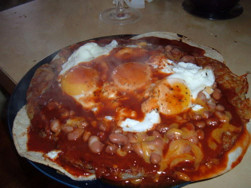 The Royal Flush A pile of 3 sunny side up eggs, beans, red chile sauce, cheddar cheese, 4 corn tortillas and 3 hash browned potatoes. (submitted by Joseph Zobel)